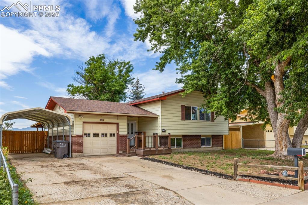 336 Harvard Street Colorado Springs, CO 80911 - Photo 2 of 27 a front view of a house with a yard and garage
