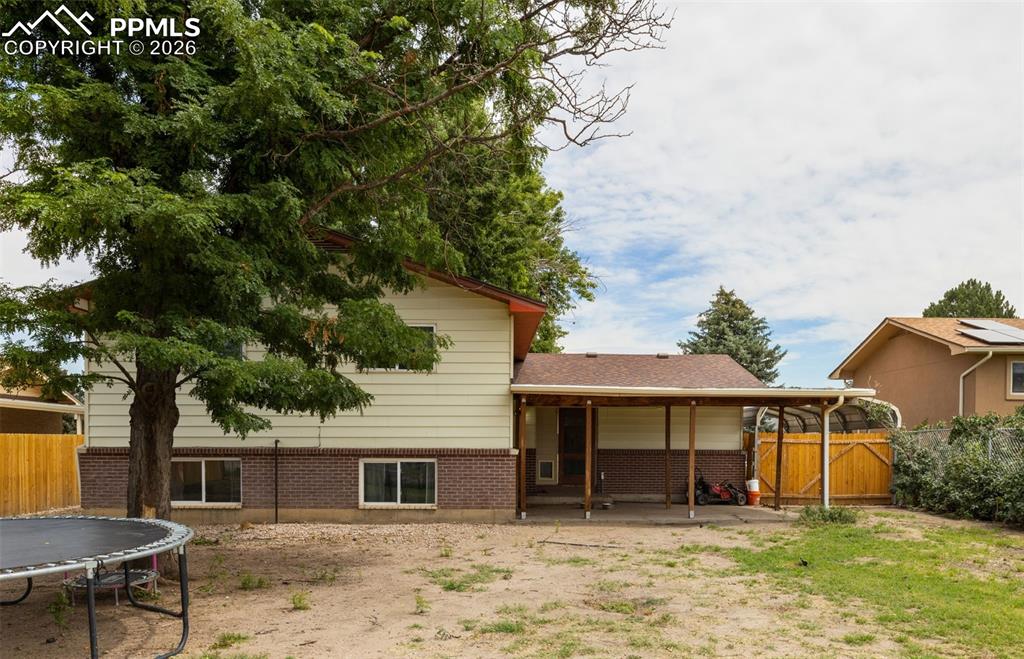 336 Harvard Street Colorado Springs, CO 80911 - Photo 25 of 27 a front view of a house with a yard and a garage