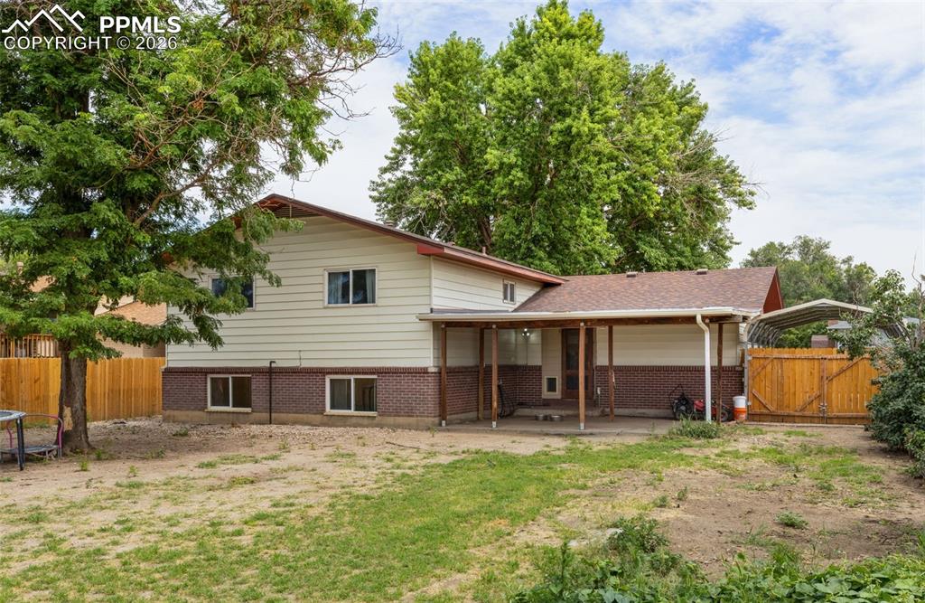 336 Harvard Street Colorado Springs, CO 80911 - Photo 26 of 27 a front view of a house with a yard and garage