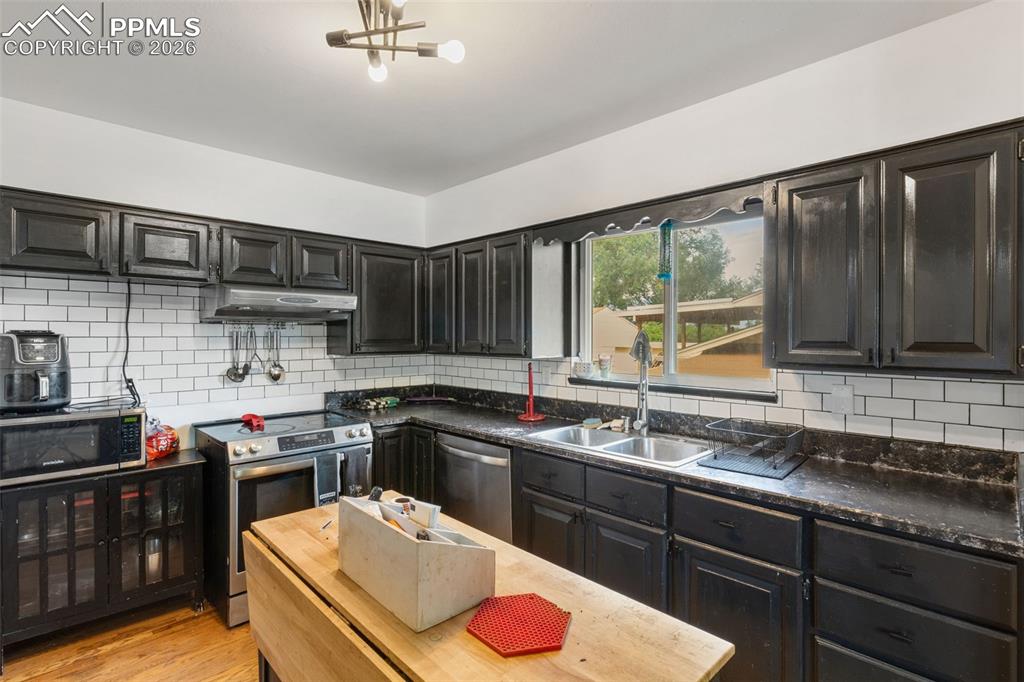 336 Harvard Street Colorado Springs, CO 80911 - Photo 8 of 27 a kitchen with stainless steel appliances granite countertop a sink stove and cabinets