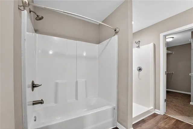 a bathroom with a bathtub and a shower