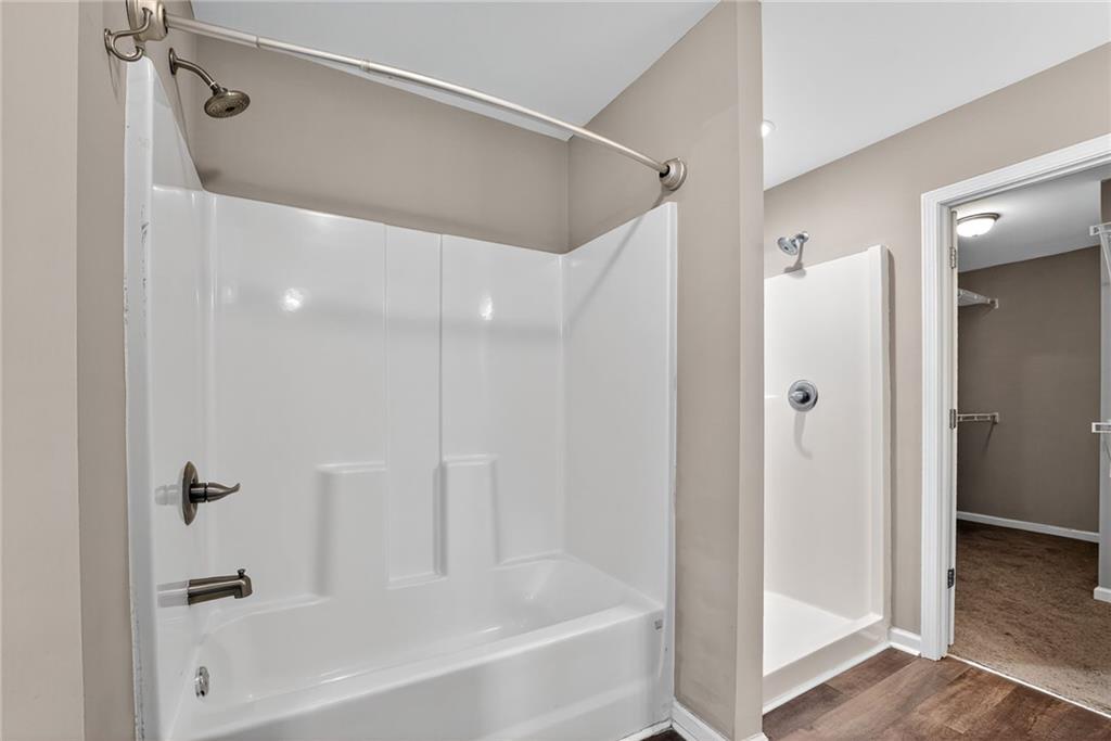 3369 Hidden Stream Court Stockbridge, GA 30281 - Photo 14 of 22 a bathroom with a bathtub and a shower