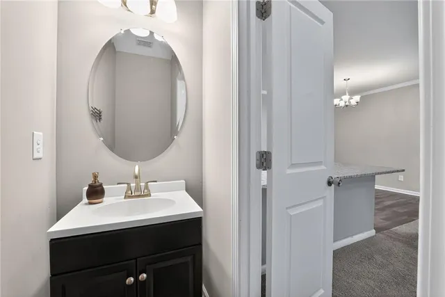 a bathroom with a sink vanity and a mirror