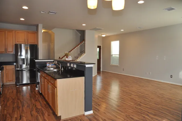 a kitchen with stainless steel appliances granite countertop a stove and a refrigerator