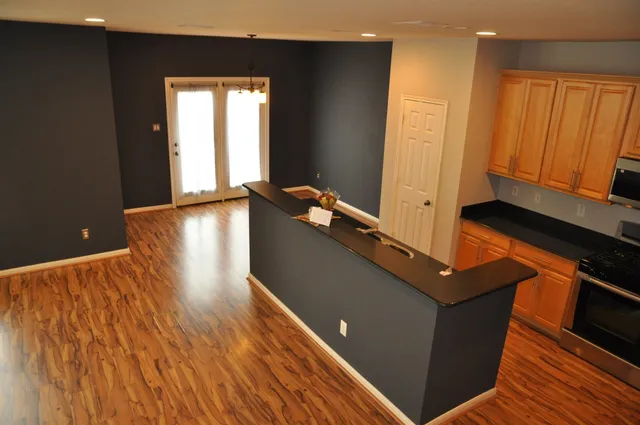 a view of a room with wooden floor