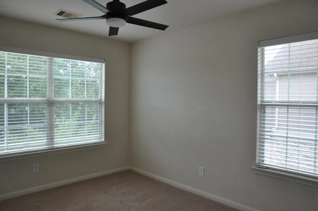 a view of a house with a wooden fence