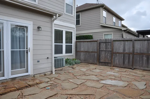 a view of backyard with wooden fence