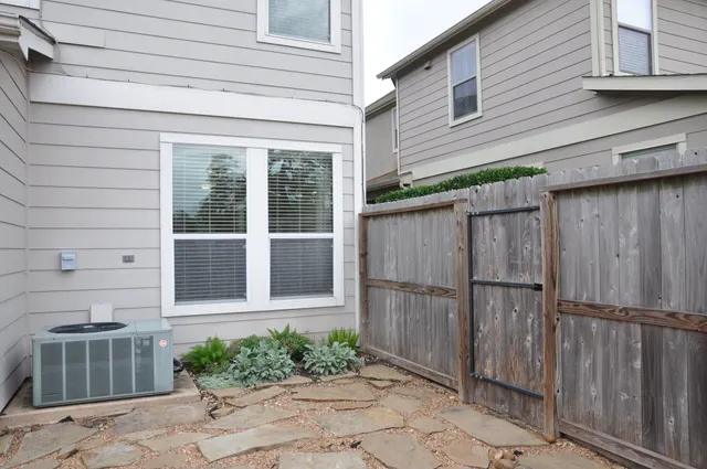 a view of a backyard with wooden fence