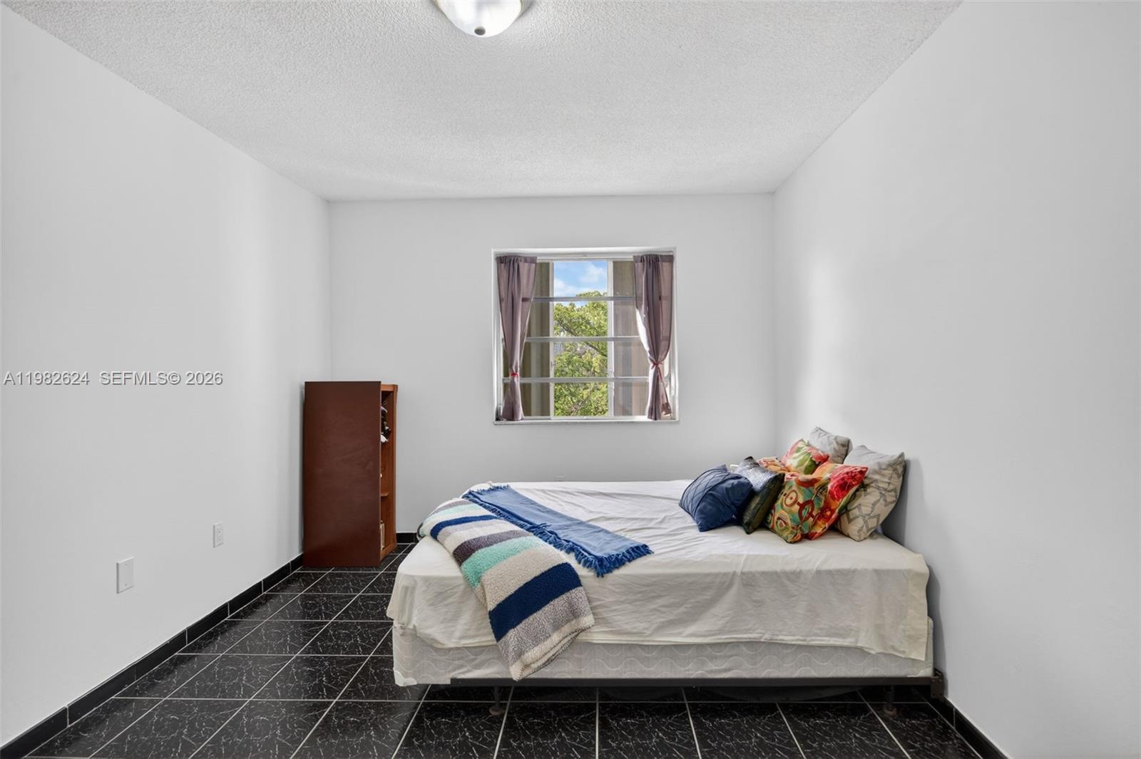 3181 Southwest 13th Street, Unit 416 Miami, FL 33145 - Photo 12 of 40 a bedroom with a bed and a window