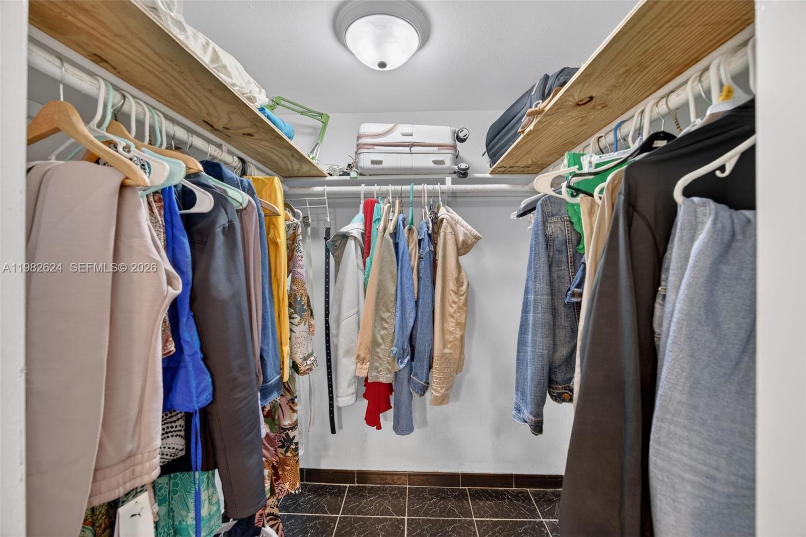 3181 Southwest 13th Street, Unit 416 Miami, FL 33145 - Photo 17 of 40 a view of walk in closet with clothes and shoes