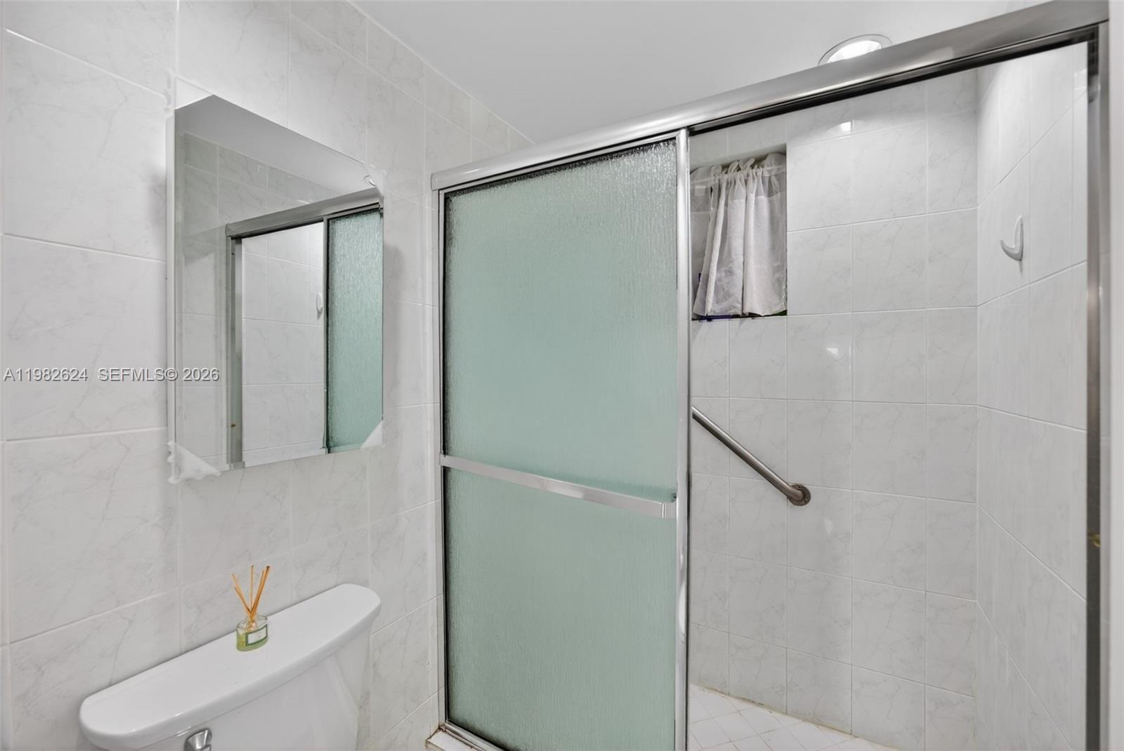 3181 Southwest 13th Street, Unit 416 Miami, FL 33145 - Photo 18 of 40 a bathroom with a shower and a toilet