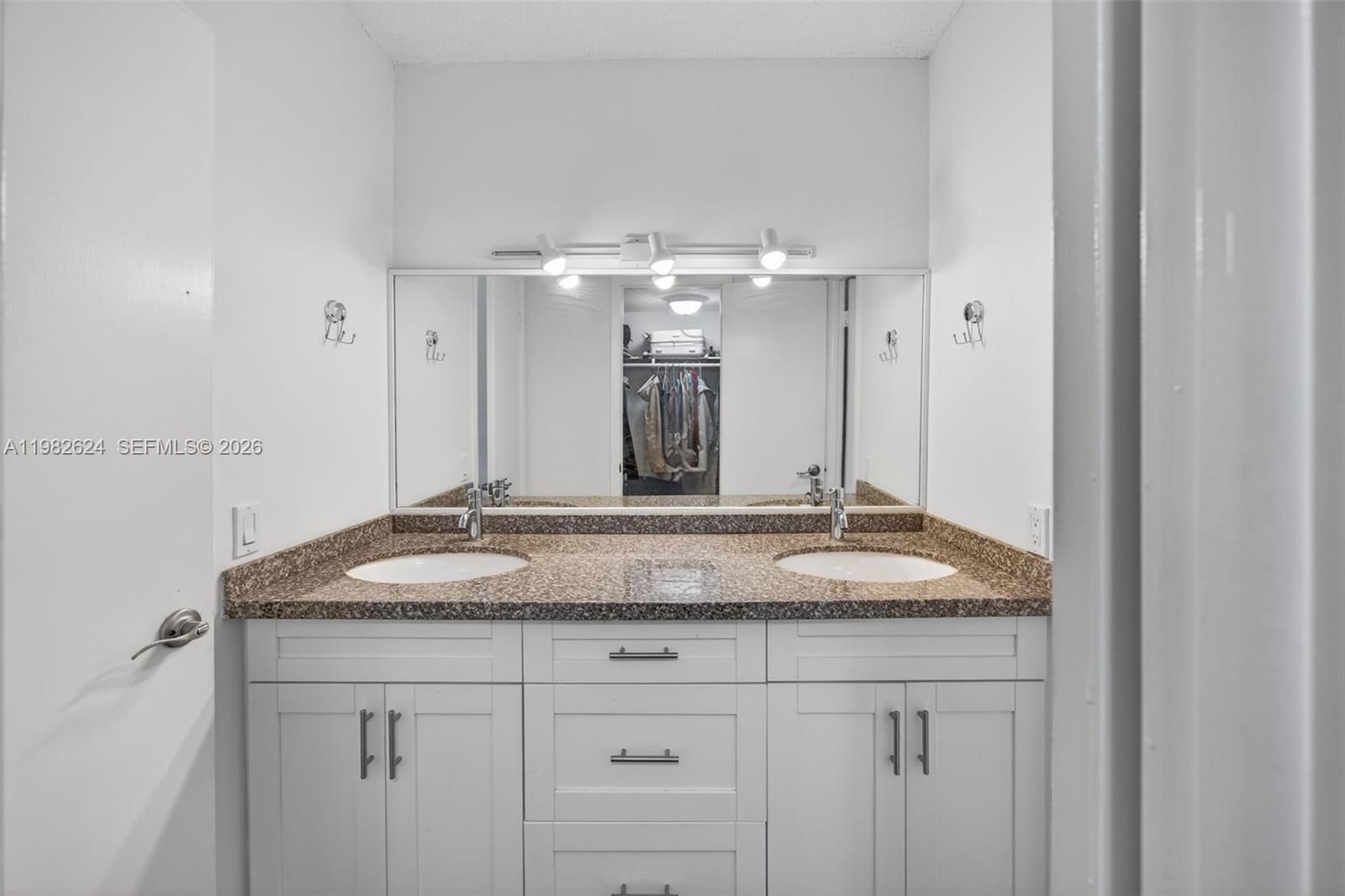 3181 Southwest 13th Street, Unit 416 Miami, FL 33145 - Photo 20 of 40 a bathroom with a granite countertop sink and a mirror