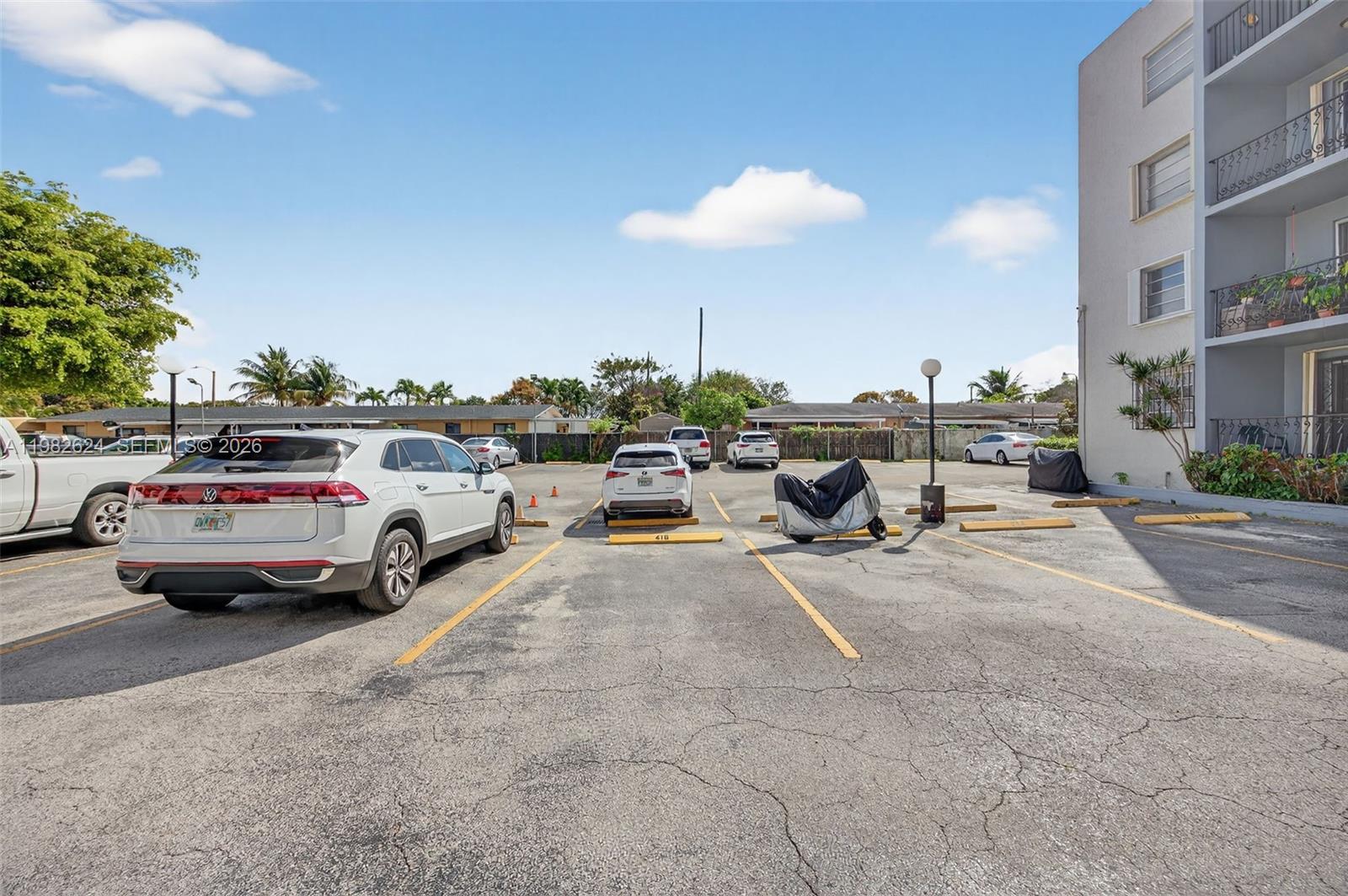 3181 Southwest 13th Street, Unit 416 Miami, FL 33145 - Photo 32 of 40 a view of cars parked in a parking lot