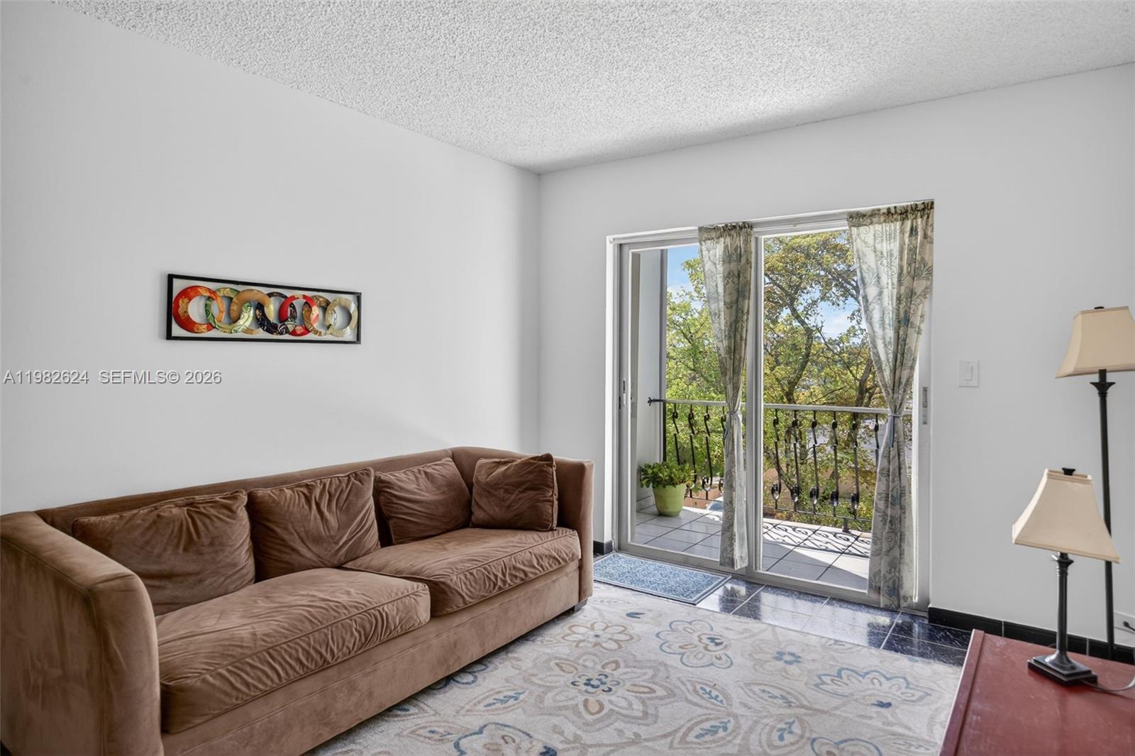 3181 Southwest 13th Street, Unit 416 Miami, FL 33145 - Photo 6 of 40 a living room with furniture and a window
