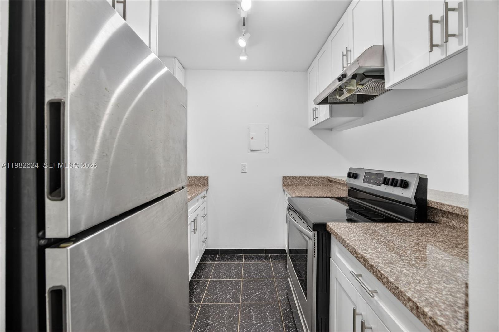 3181 Southwest 13th Street, Unit 416 Miami, FL 33145 - Photo 7 of 40 a kitchen with a refrigerator and a sink