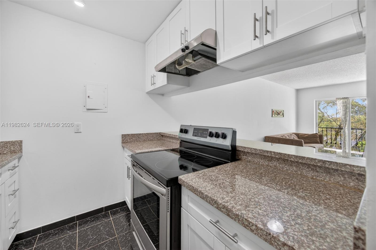 3181 Southwest 13th Street, Unit 416 Miami, FL 33145 - Photo 8 of 40 a kitchen with a stove and a sink