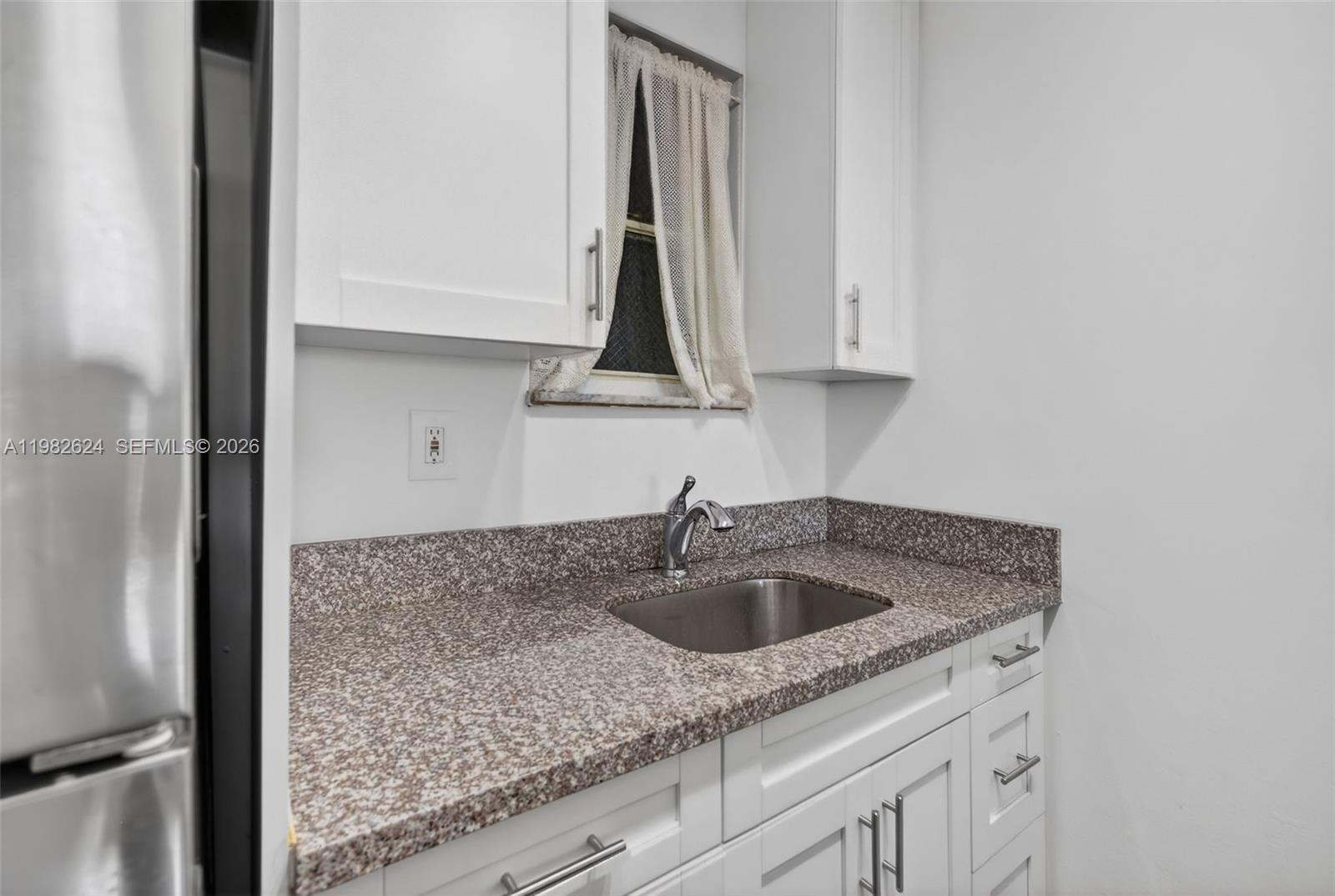 3181 Southwest 13th Street, Unit 416 Miami, FL 33145 - Photo 9 of 40 a kitchen with a sink and cabinets