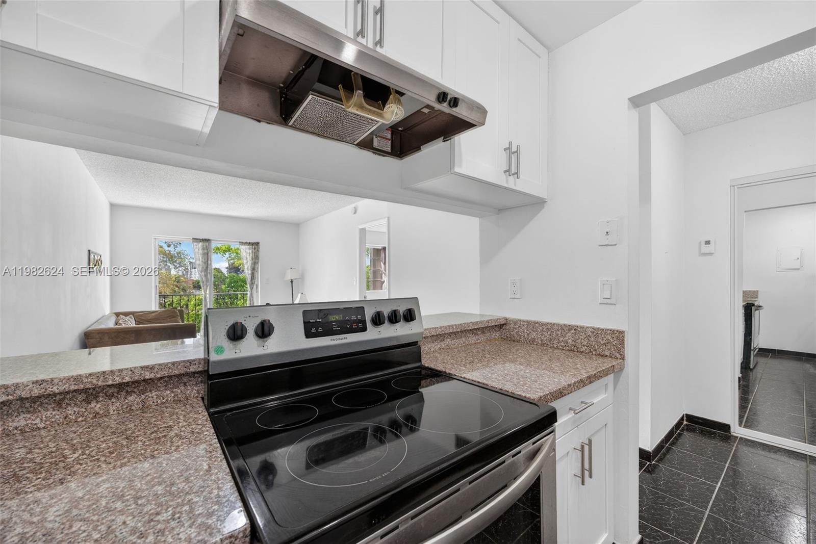 3181 Southwest 13th Street, Unit 416 Miami, FL 33145 - Photo 10 of 40 a kitchen with a stove and a microwave