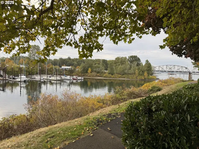 a view of a livingroom with wooden floor and a bathroom