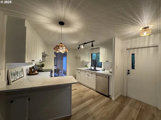 a large kitchen with cabinets and stainless steel appliances