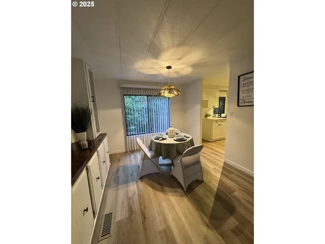 a view of a dining room with a table and chairs