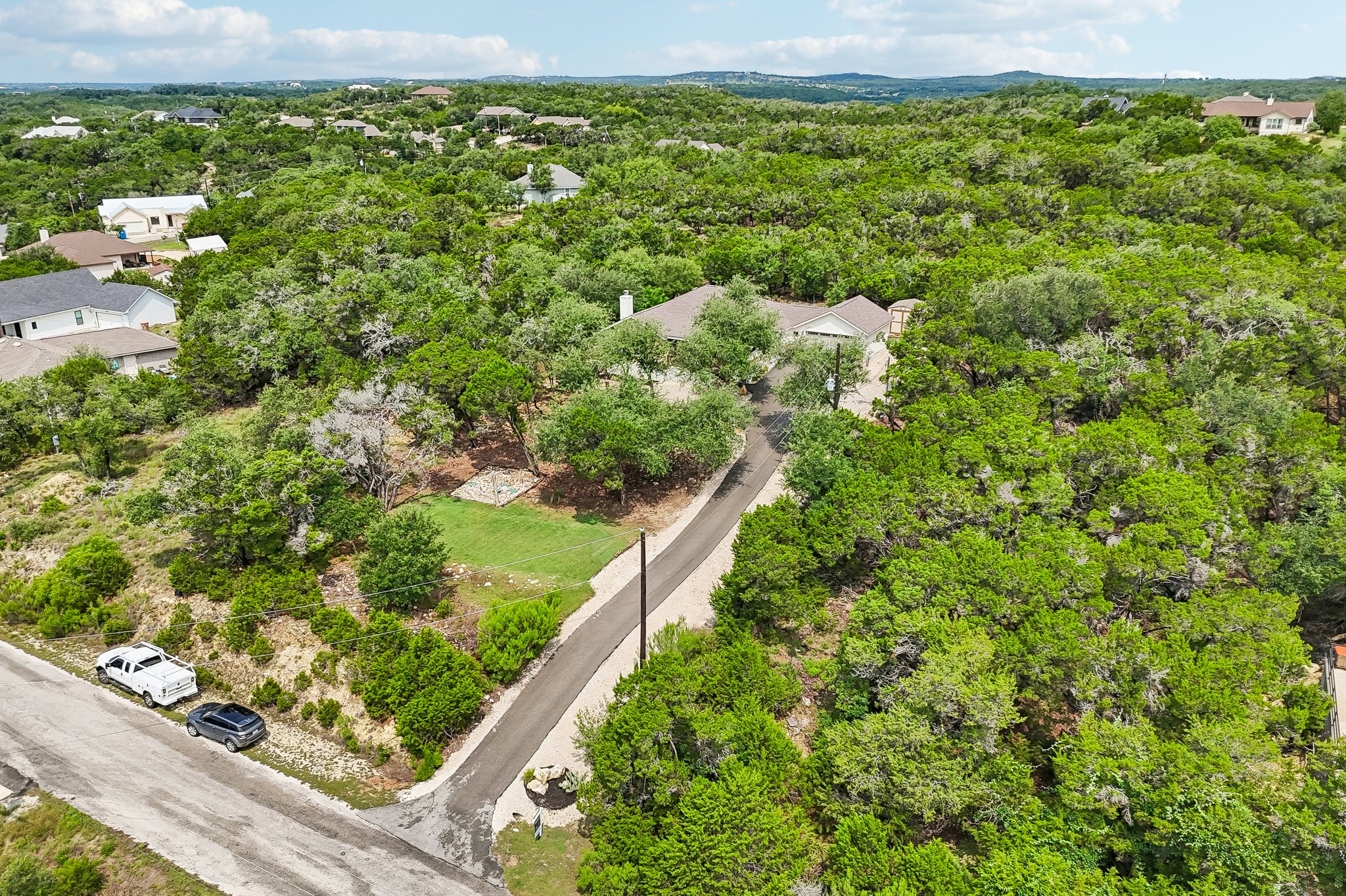 190 Magnolia Meadow Spring Branch, TX 78070 - Photo 25 of 29 A secluded dwelling nestled amidst verdant hills, offering a private, tree-lined retreat.