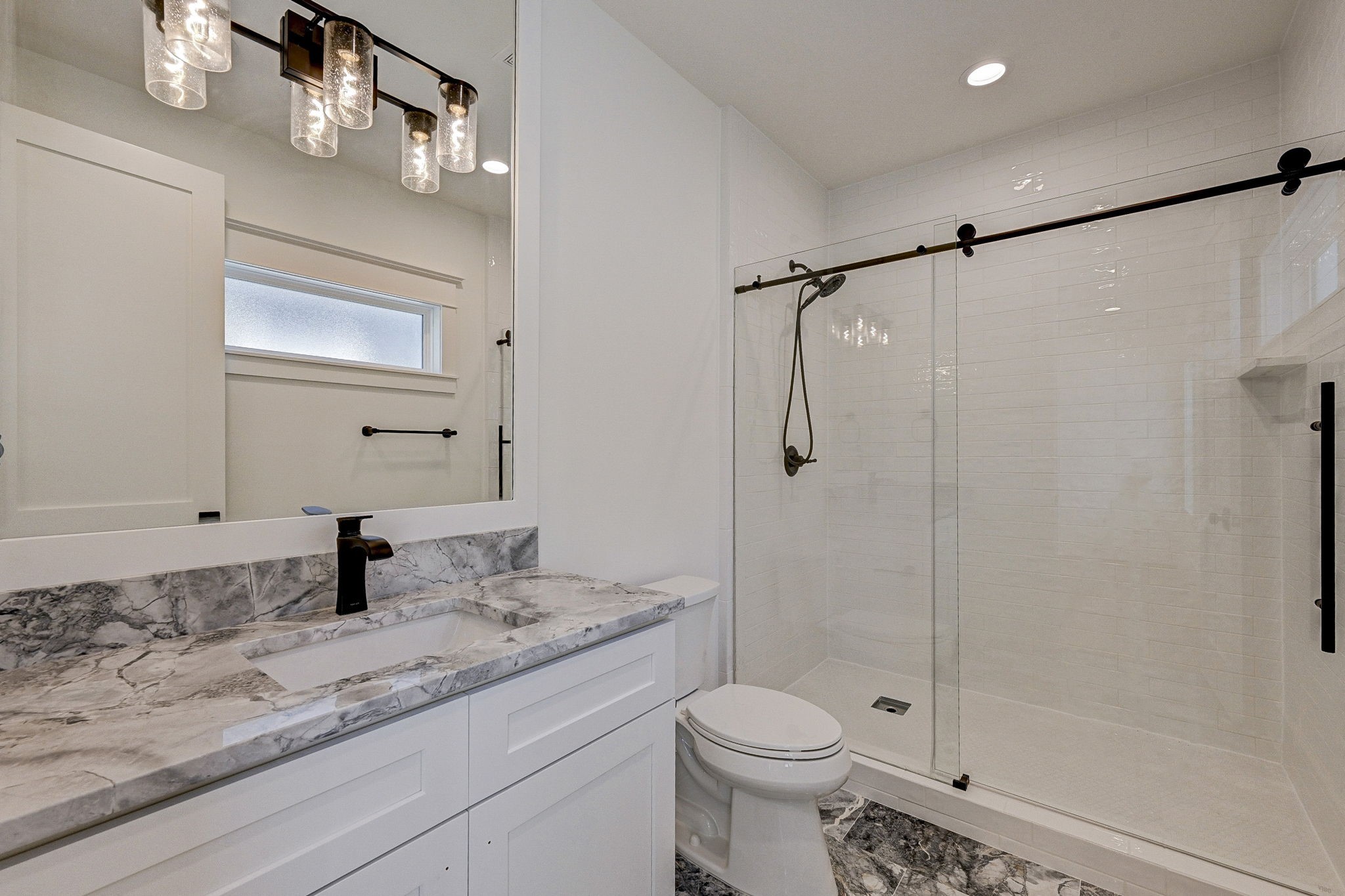 1520 Nicholson Street Houston, TX 77008 - Photo 30 of 39 a bathroom with a granite countertop sink a toilet and shower