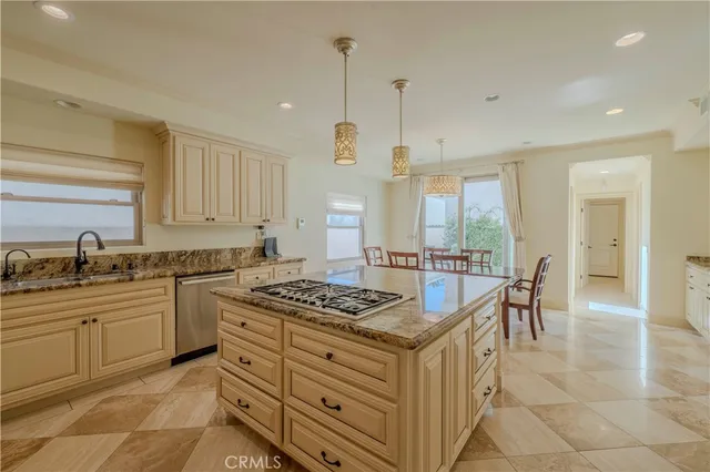 a kitchen with a table chairs sink and cabinets
