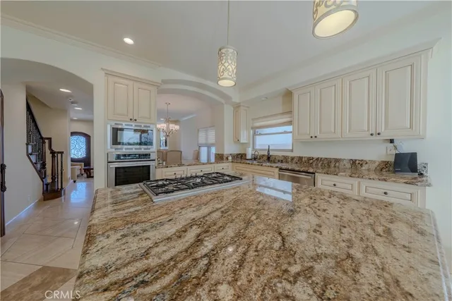 a kitchen with white cabinets and appliances