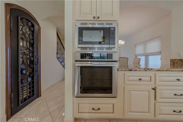 a kitchen with stainless steel appliances granite countertop a refrigerator and a stove top oven