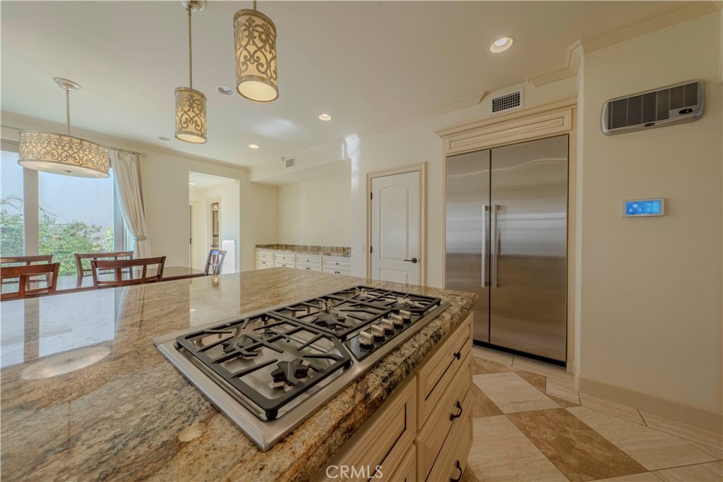 525 15th Street Huntington Beach, CA 92648 - Photo 19 of 46 a kitchen with stainless steel appliances granite countertop a refrigerator and a stove top oven