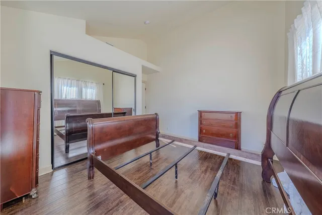 a view of workspace with wooden floor table and windows