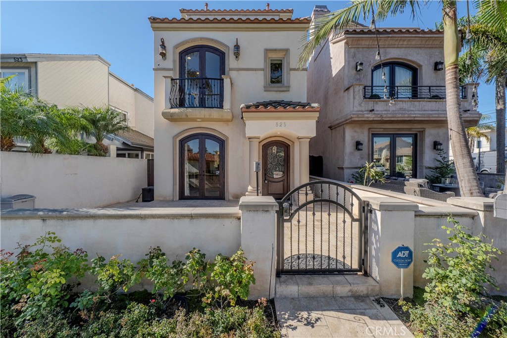 525 15th Street Huntington Beach, CA 92648 - Photo 3 of 46 a front view of a house with a garden