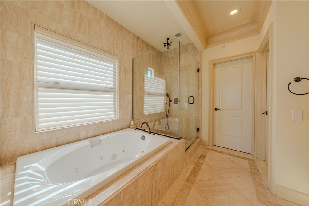 525 15th Street Huntington Beach, CA 92648 - Photo 34 of 46 a bathroom with a bathtub and a shower
