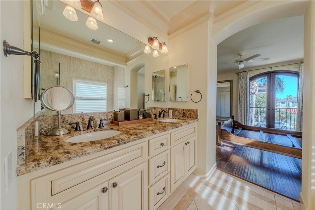 525 15th Street Huntington Beach, CA 92648 - Photo 37 of 46 a spacious bathroom with a granite countertop sink mirror and vanity