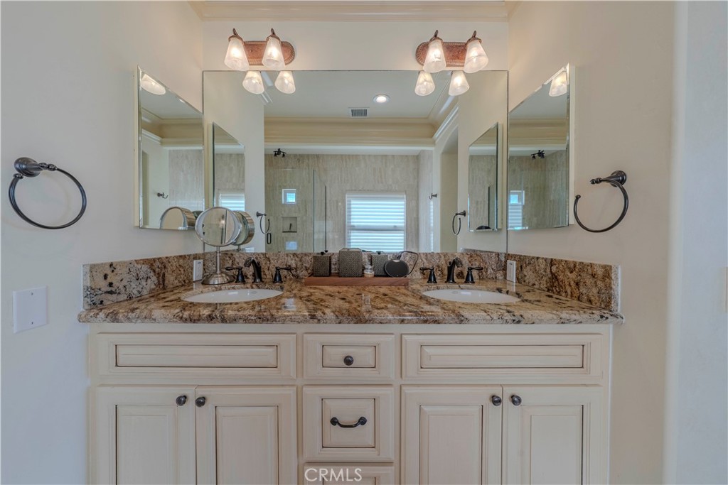 525 15th Street Huntington Beach, CA 92648 - Photo 38 of 46 a bathroom with a sink vanity and a mirror