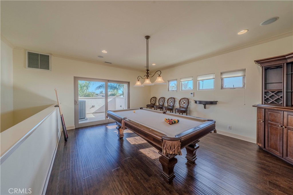 525 15th Street Huntington Beach, CA 92648 - Photo 42 of 46 a room with furniture pool table wooden floor and windows