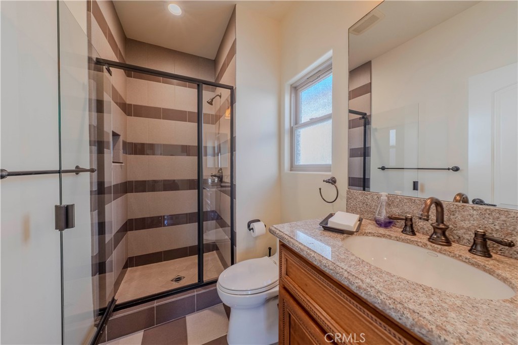 525 15th Street Huntington Beach, CA 92648 - Photo 43 of 46 a bathroom with a granite countertop sink toilet and shower