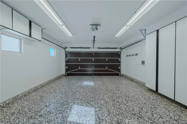 a view of room with stairs and a refrigerator