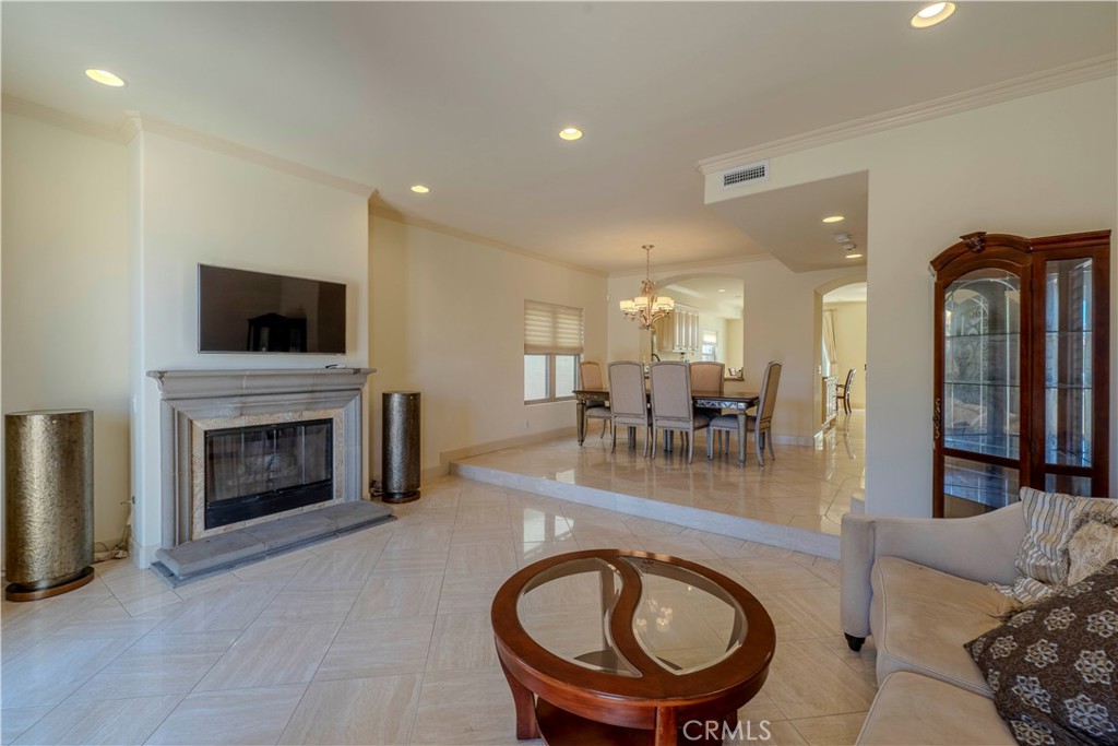 525 15th Street Huntington Beach, CA 92648 - Photo 7 of 46 a living room with furniture a fireplace and a flat screen tv