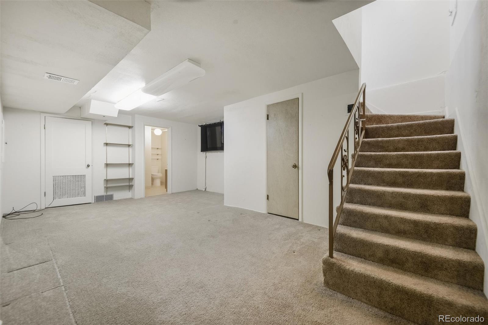101 Hudson Street Denver, CO 80220 - Photo 17 of 27 a view of an empty room with a ceiling fan