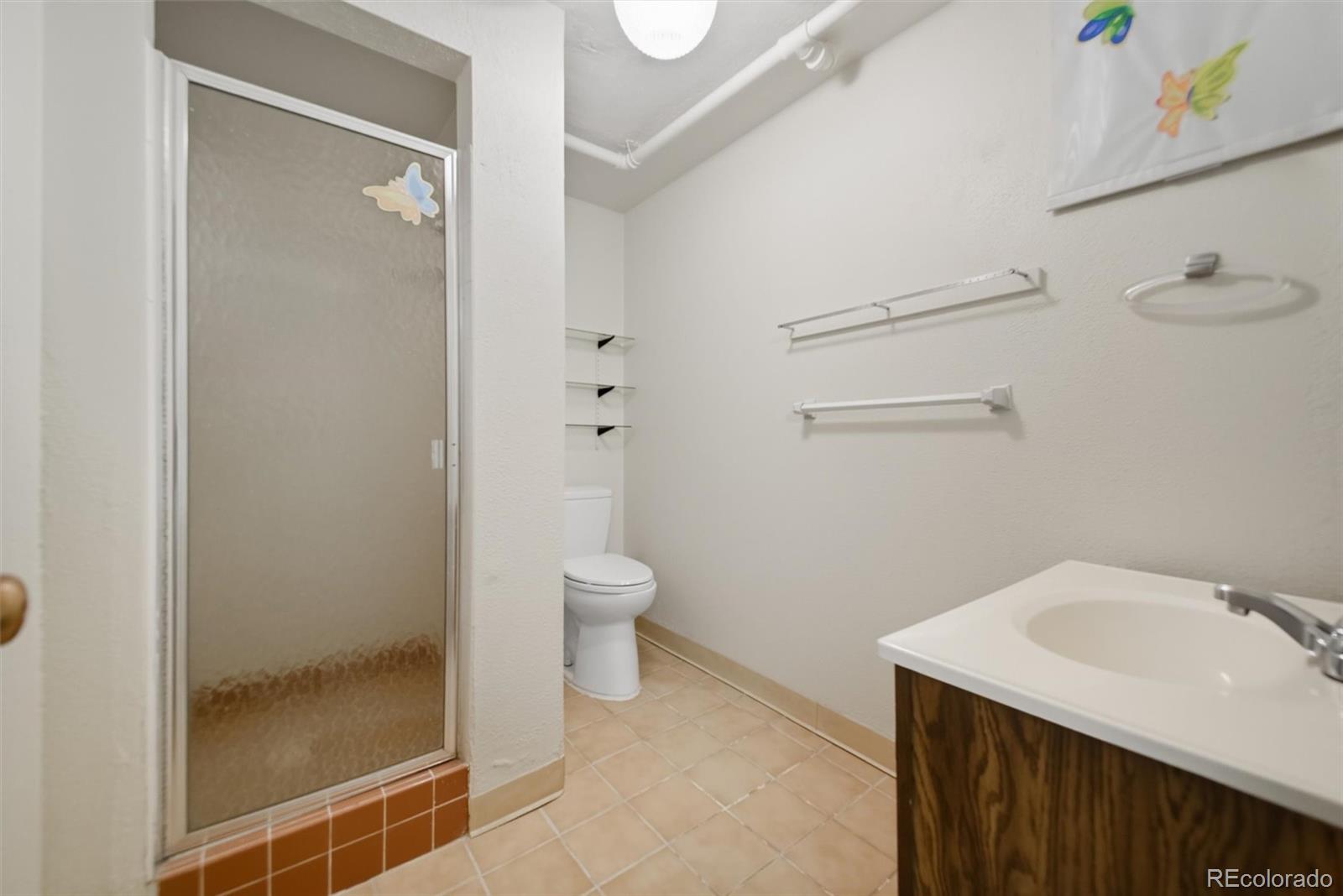 101 Hudson Street Denver, CO 80220 - Photo 18 of 27 a bathroom with a sink a toilet and shower