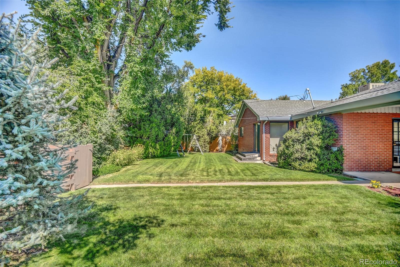 101 Hudson Street Denver, CO 80220 - Photo 26 of 27 a view of a backyard with large trees