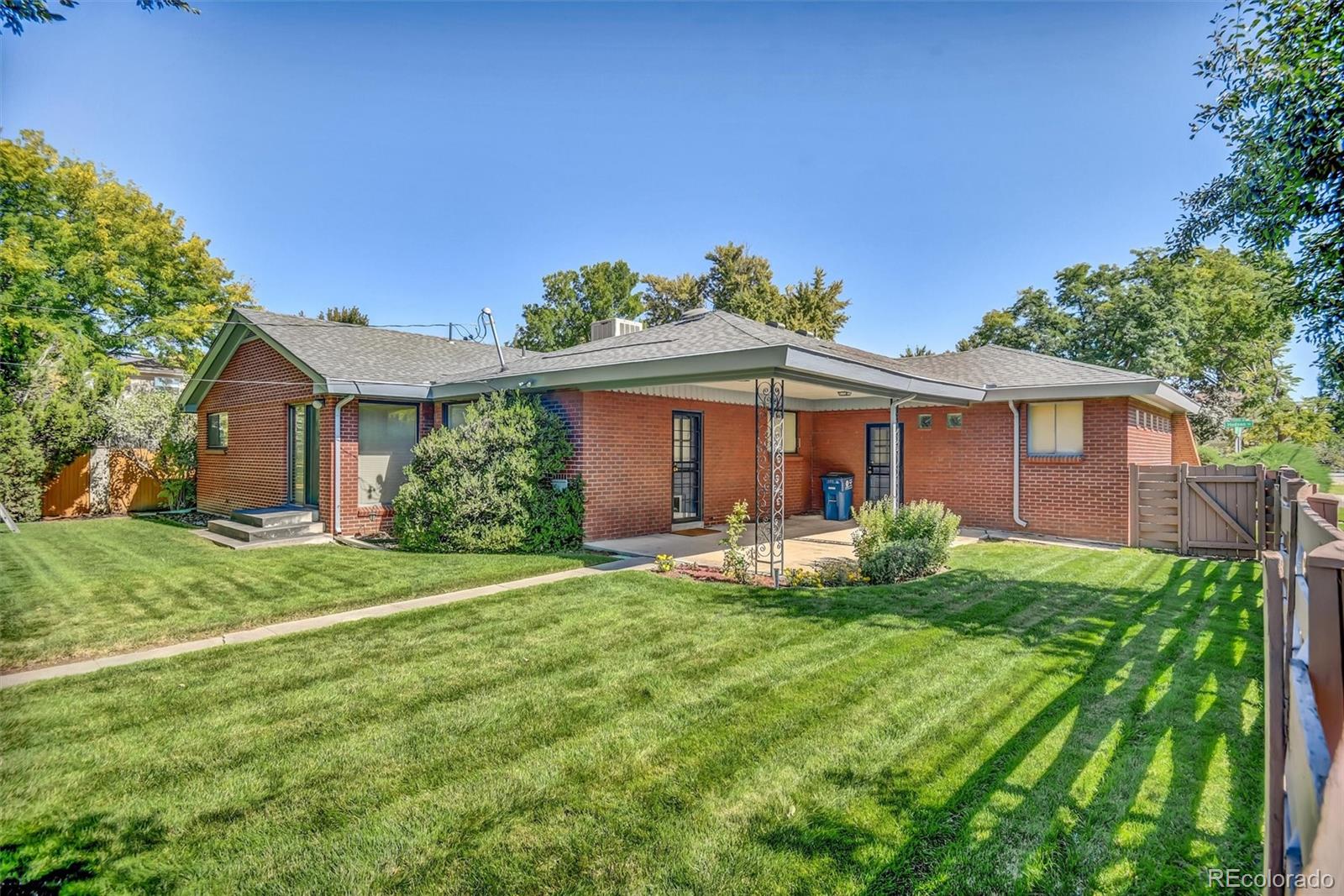 101 Hudson Street Denver, CO 80220 - Photo 27 of 27 a front view of a house with a yard and porch