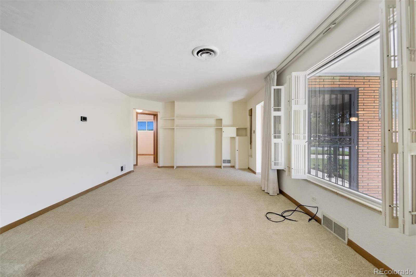 101 Hudson Street Denver, CO 80220 - Photo 4 of 27 a view of an empty room with a window