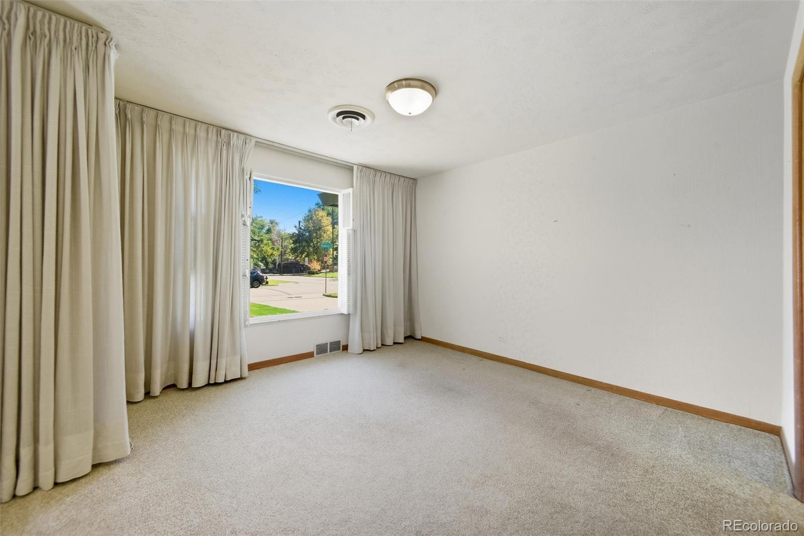 101 Hudson Street Denver, CO 80220 - Photo 5 of 27 an empty room with windows