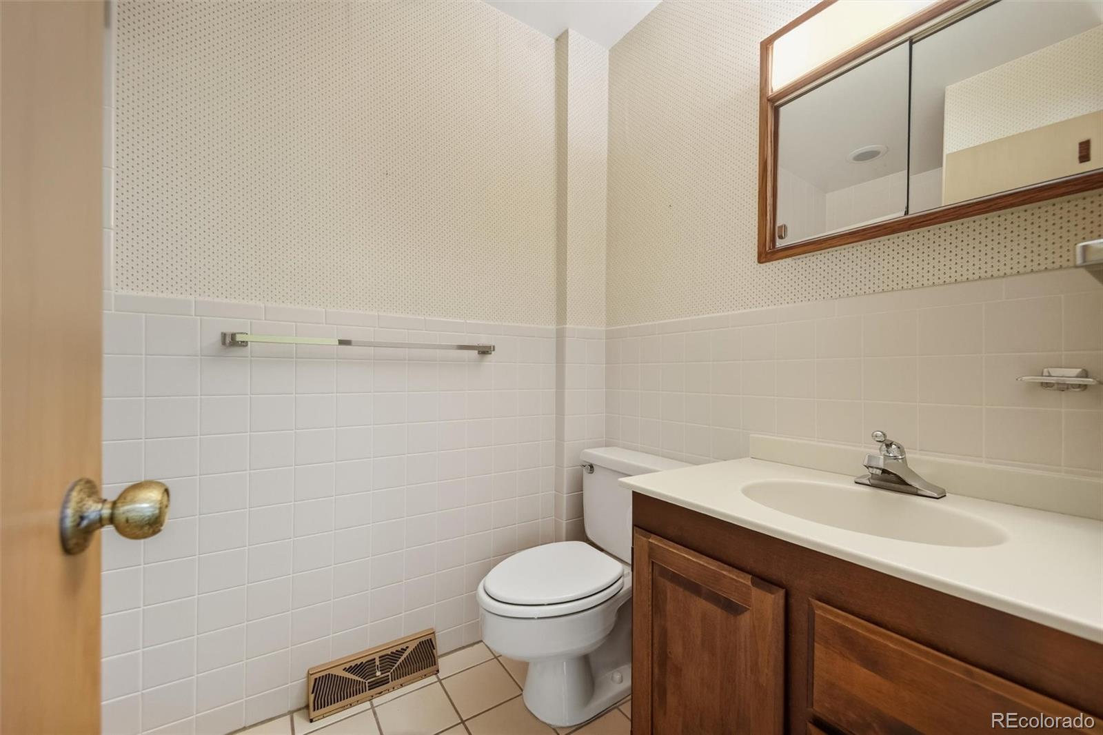 101 Hudson Street Denver, CO 80220 - Photo 10 of 27 a bathroom with a sink a toilet and mirror