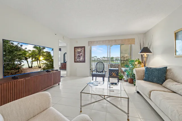 a living room with a large window and a table