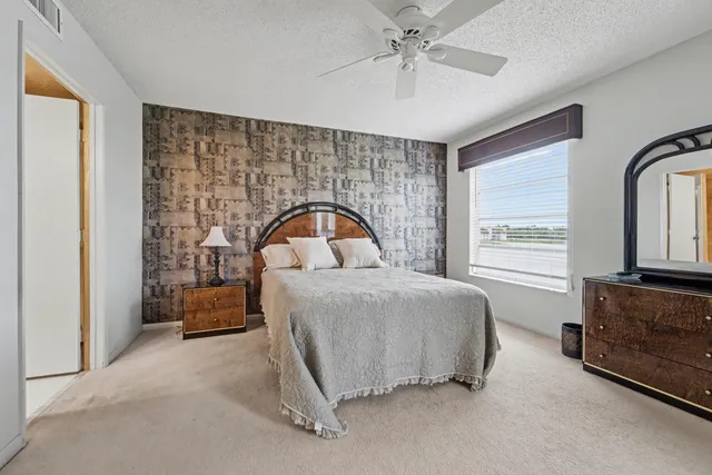 a bedroom with a large bed and a large window