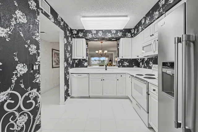 a view of a dining room with furniture and chandelier